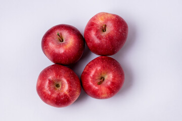 Four Tasty Red Apples on Blue Background Top View Horizontal