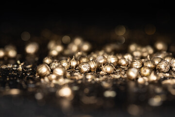 Shining golden particles abstract background. Blurred bokeh background of gold dust particles...