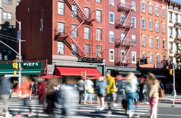 Fotobehang New York Busy street scene with crowds of people walking through the intersection on 7th Avenue and Bleecker in the Greenwich Village neighborhood of New York City  © deberarr