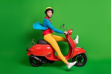 Fototapeta na wymiar Full size profile side photo of young beautiful shocked amazed girl ride fast red moped isolated on green color background