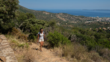 Girl hiking in the Provence countryside during the summer
