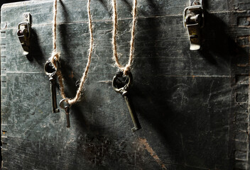 Fototapeta na wymiar Three aged keys on the wooden chest.Treasure and pirates symbols