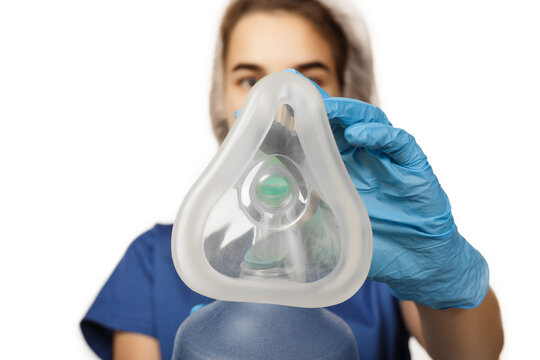 Woman hand doctor in blue gloves holds a bag of am-bu for artificial ventilation of the lungs and puts on the patient first-person view (view from the patient) isolated on white background - Powered by Adobe