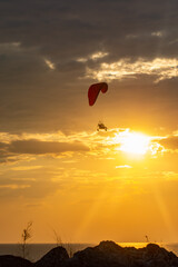 Paragliding. Paraglider flying in the sunset sky 