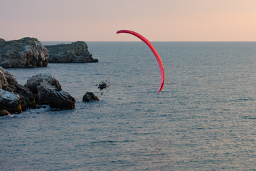 Paragliding. Paraglider flying in the sunset sky 