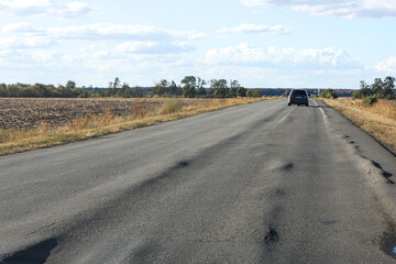 terrible road with longitudinal rut. Poor asphalt surface