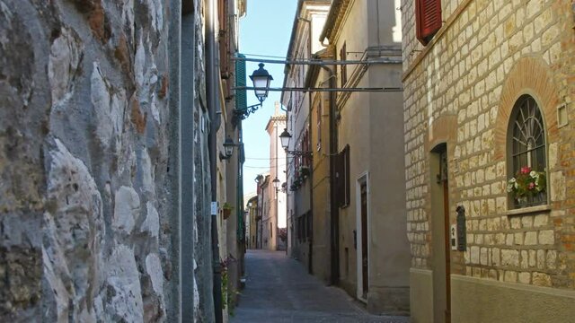 Narrow&nbsp;street&nbsp;and&nbsp;houses&nbsp;with&nbsp;exposed&nbsp;old&nbsp;brick&nbsp;walls of Sirolo village in the center of Italy, Ancona area in the Marche region &ndash; Typical italian building style &ndash; Real Time 4K
