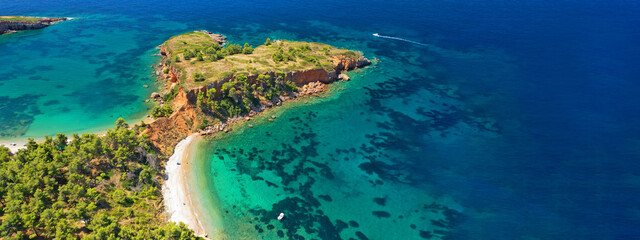 Aerial ultra wide panoramic view of tropical paradise rocky bay visited by sailboats and yachts in Caribbean exotic destination island