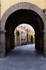 Fototapeta na wymiar Ancient alley of Lucca with arch