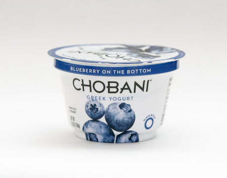 Container of blueberry Chobani Greek yogurt against white background.