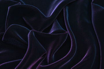 Dark purple velvet fabric background texture.