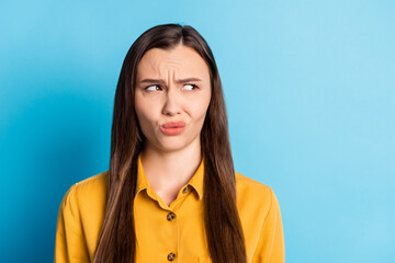 Photo of dissatisfied irritated lady look empty space grimacing ugly smell isolated on blue color...