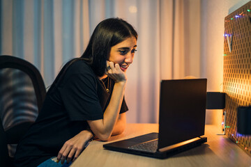 Chica joven morena haciendo vlogs en su cuarto y trabajando en el pc