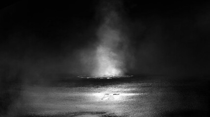 Dark street, black background, glare of light on the wet asphalt. Rays and lines, smoke. Dark city...