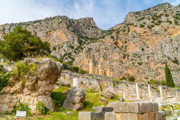 Fototapeta na wymiar Ruins of the Stoa of Athenians at the ancient ruin site of Delphi, Greece with mountains in the background