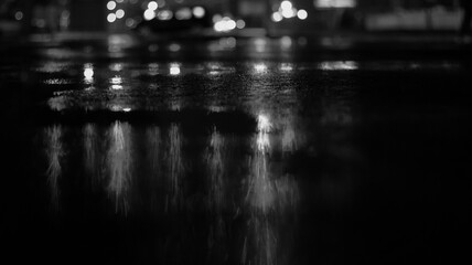 Dark street, black background, glare of light on the wet asphalt. Rays and lines, smoke. Dark city...