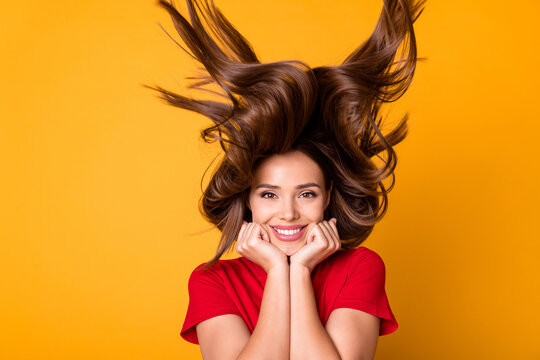 Photo of funny lady with flying hairstyle hold arms on cheeks wear casual red top isolated yellow color background