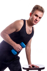 Young sportsman making exercises with dumbbels studio portrait on white background,