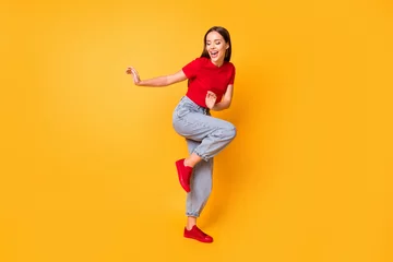 Foto op Canvas Full length photo of dancing lady at students party wear red crop top jeans shoes isolated yellow color background © deagreez
