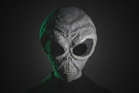 Alien face close up on dark background. Ufo concept.