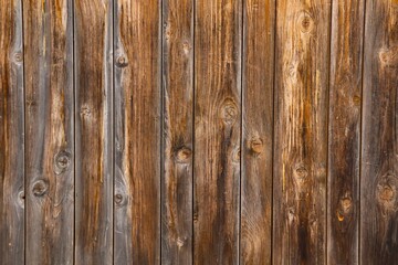 Texture of a wooden panel made of weathered and sun-burnt boards