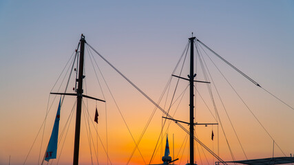 Beautiful shot of a silhouette of sailboat masts at sunset