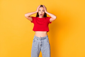 Photo of shocked terrified lady hands on head open mouth wear red crop top jeans isolated on bright yellow color background