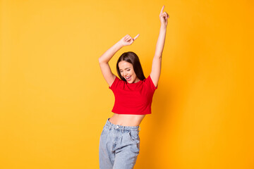 Charming lady having fun raise hands moving dance floor wear red crop top jeans isolated over...