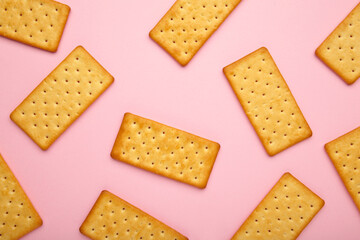 Cracker on pink background with copy space.