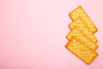 Cracker on pink background with copy space.