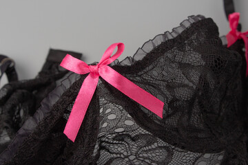delicate pink bow on black lace lingerie - Powered by Adobe