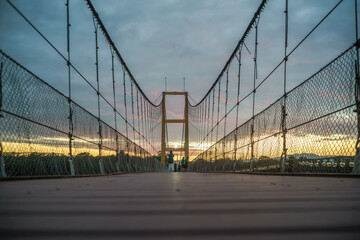 Wooden bridge across the River in the evening.