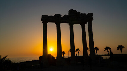 Temple of Apollo at sunset / Tourists are posing at the temple of Apollo as the best-recognized symbol of the Side, Turkey