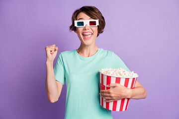 Photo of lucky lovely young lady wear casual teal outfit 3d eyewear holding pop-corn box isolated purple color background