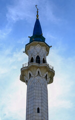 Minaret against the blue sky. Close-up.