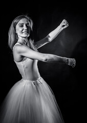 Fototapeta premium Young beautiful woman in a tutu studio portrait.