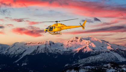 Yellow Helicopter flying over the Rocky Mountains. Dramatic Sunrise. Aerial Landscape from British...