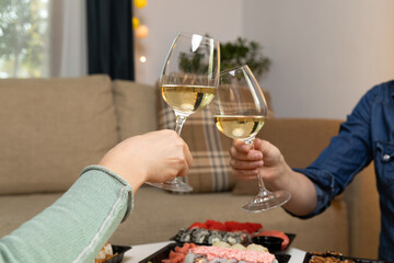 Two women holding wine glasses in hands and celebrating. Communication and friendship concept