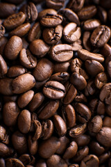 Coffee beans close up against the background of a coffee beans. Morning espresso. Coffee mug. 