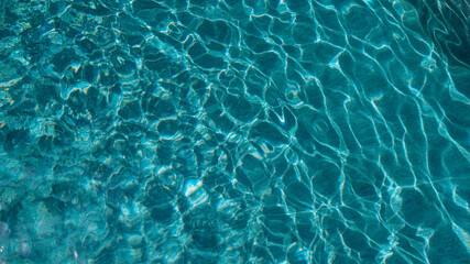 Abstract pool water.  Swimming pool bottom caustics ripple and flow with waves background surface of blue swimming pool