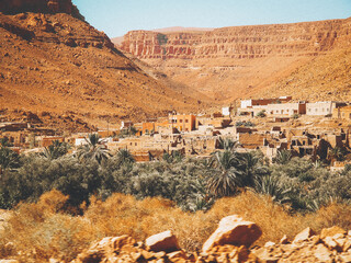 A typical ancient Berber village middle of the oasis in the desert in North Africa/Morocco. Berber homes made of clay.