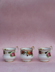 Vintage tea cup on pink background.