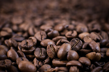 Coffee beans close up against the background of a coffee beans. Morning espresso. Coffee mug. 