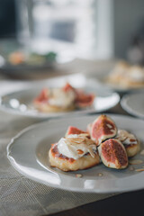 Traditional cottage cheese pancakes, cheesecake on a plate sour cream and nuts sauce, pieces of figs.