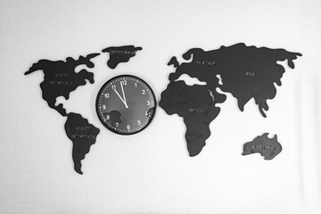 A clock with a world map on a white background