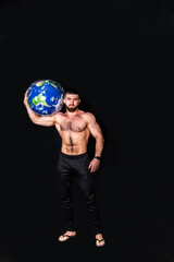 handsome physically well-developed man with a mock planet earth in his hands