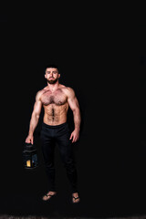 Naklejka premium handsome physically well-developed man with a mock planet earth in his hands