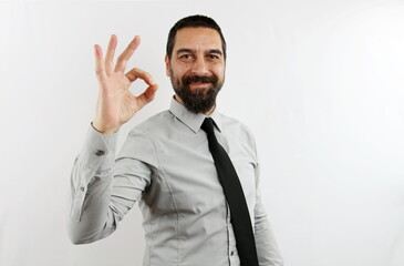 A businessman in a shirt and tie with smiling face on a white background, makes the ok gesture with his hand. Bisness concept