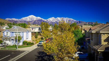 Aerial view of snow covered San Bernardino Peak in the San Bernardino mountains towering over the Yucaipa Valley, California on an clear, Autumn day