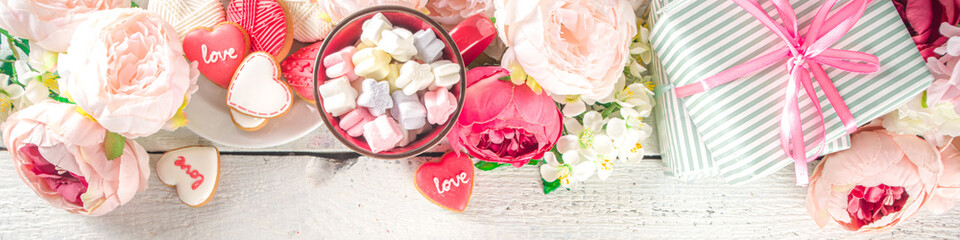 Valentine day background with Tender Pink Red White Peony Flowers and Heart Shaped Valentine Day Decor, Wooden White Background copy space